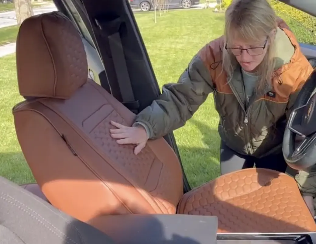 Owner fitting the caramel front cover on her SUV seat