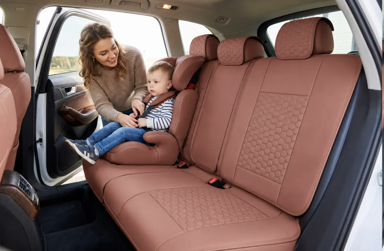 A mother buckling her child into the back seat on caramel Harlow covers